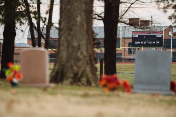 The scoreboard for the Normandy High School football field can be seen from St. Peter's Cemetery, where Michael Brown Jr. is buried. (Photo © Whitney Curtis for ProPublica)